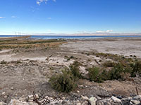 View of the broad muddy beach created by the retreat of the shoreline along the south shore of the Salton Sea. The causeway on the left was built to protect a pipeline to move Salton Sea water to mix with freshwater for marsh areas.